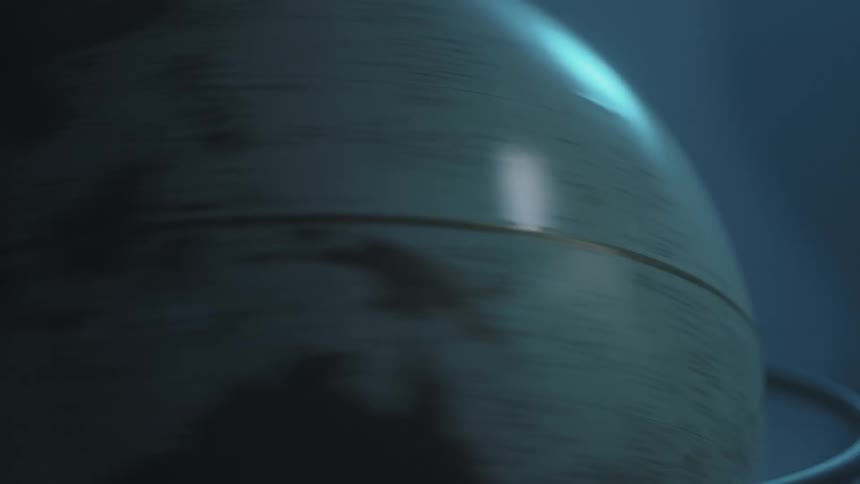 A globe spins in a room