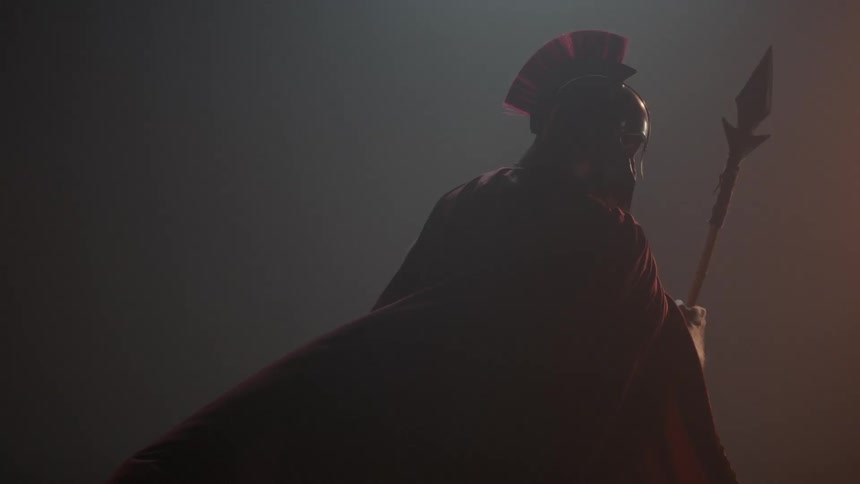 A man is wearing a helmet and holding a spear