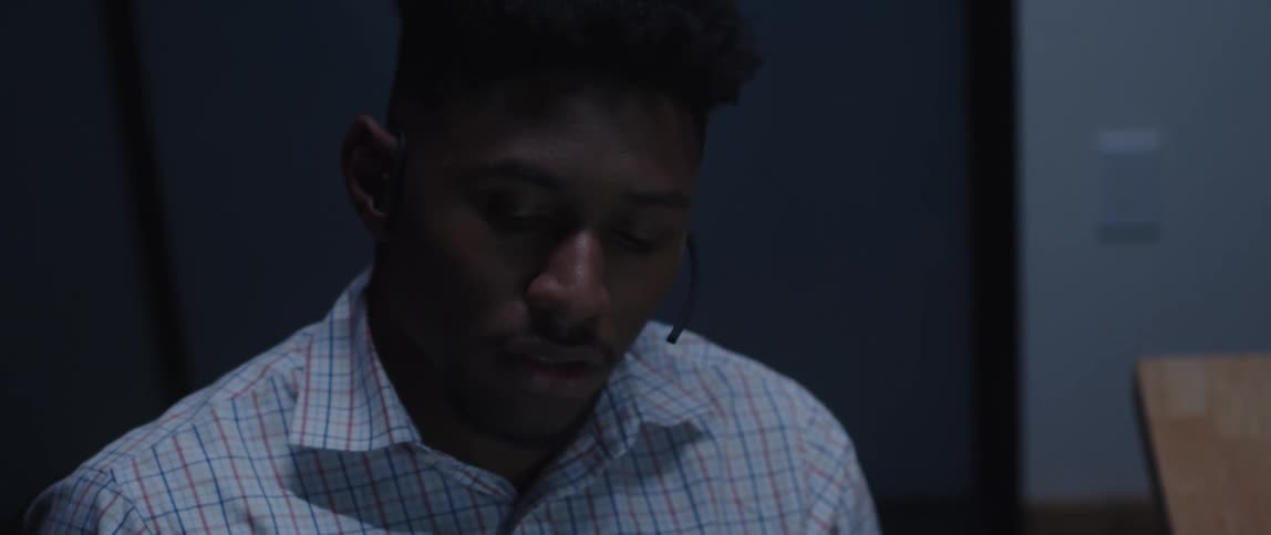 Close up of a young man working at customer service talking to a client