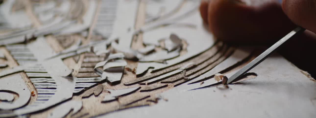 Artisan Woodworker Crafts Intricate Design with Stencil