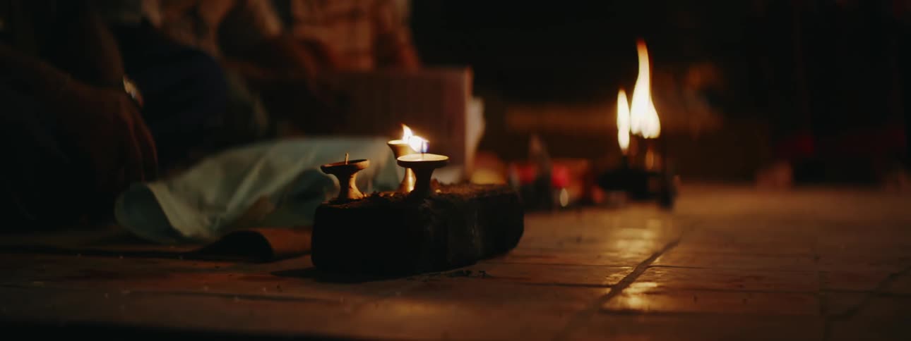 Candle-lit Gathering with People Sitting on Ground