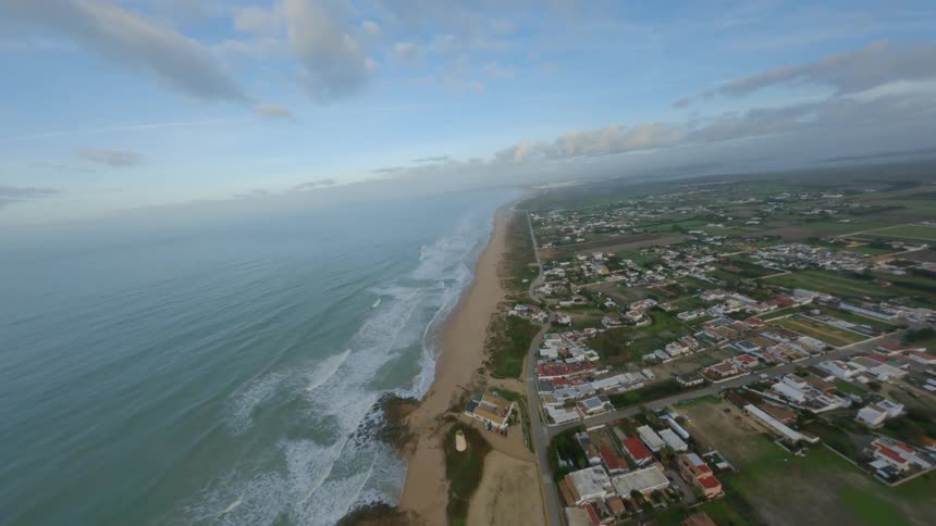 An aerial view of a coastal community on a summer morning