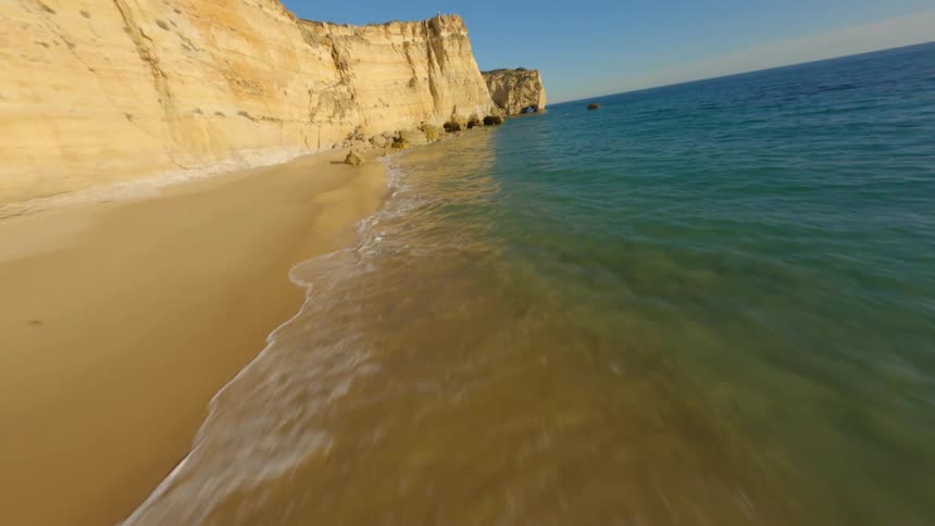 A drone zooming over a coastline
