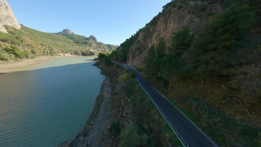 Aerial view of mountain road next to river