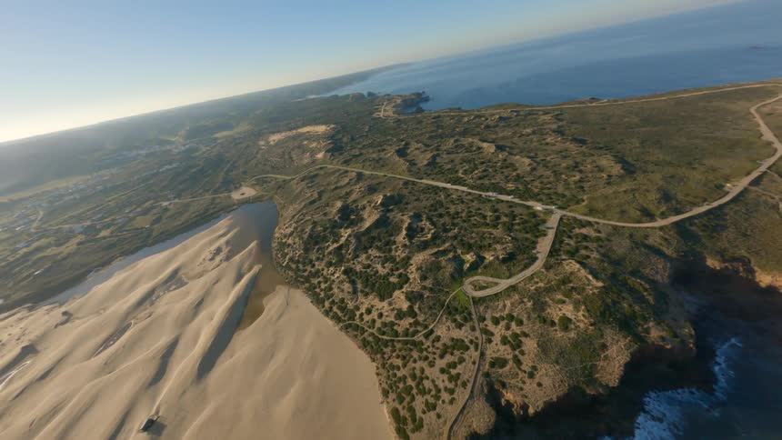 An aerial of a coast line and a peninsula with roads throughout