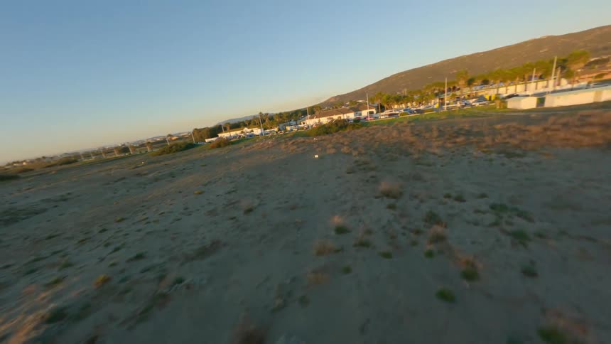 Aerial view of long beach and coastal city at sunset