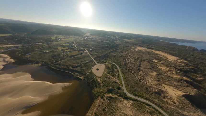 An aerial view of coastal land on a sunny clear day
