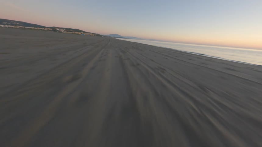 Aerial view of big long beach near the ocean at dusk