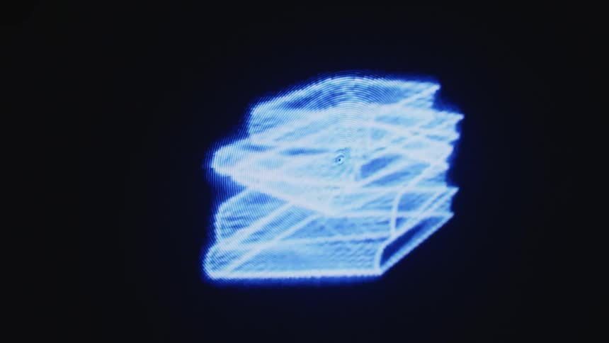 Close view of low resolution wireframe computer graphics rotating on a computer screen with a black background