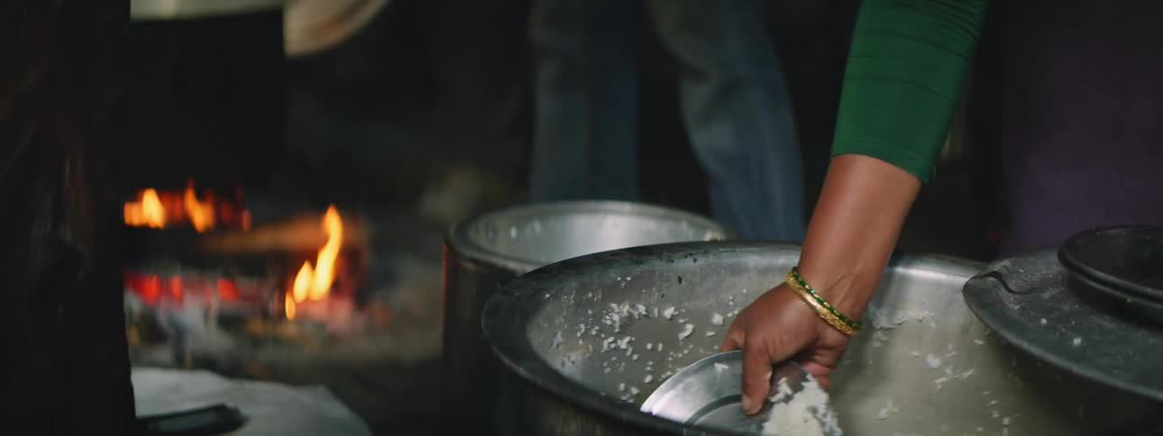 Nepalese Lady Serving Rice from a Large Pot