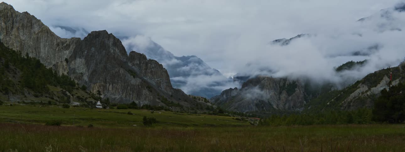 Day turns to night over a mountain range over a field