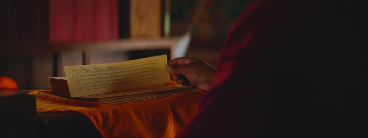 Nepalese Man Engaged with Sacred Scripture in Temple