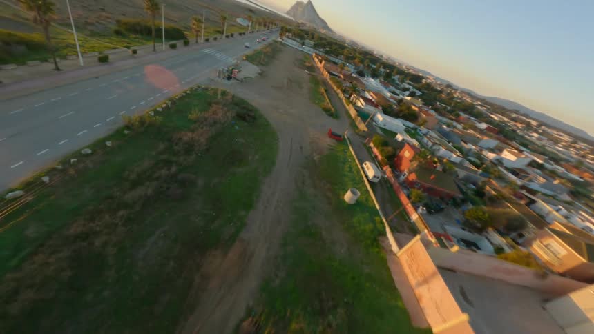 Aerial view of a beach during sunset is displayed