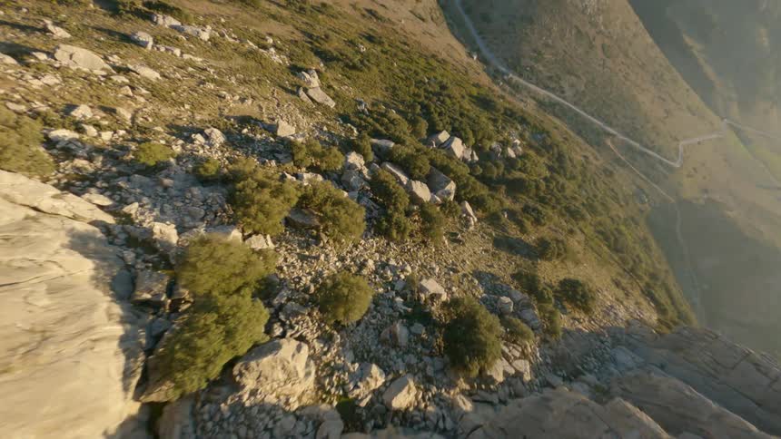 Aerial view of rocky hill and winding dirt tracks