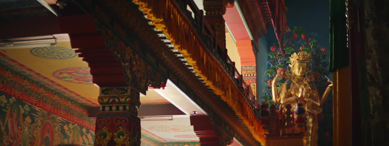 Vibrant Temple Interior: Colorful Walkway and Statue