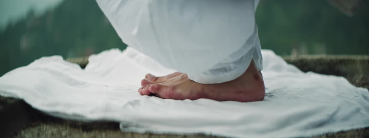 A woman lays on a blanket of some sort