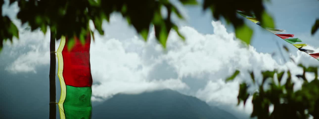 Scenic Mountain Landscape: Windy Day with Traditional Flag and Trees