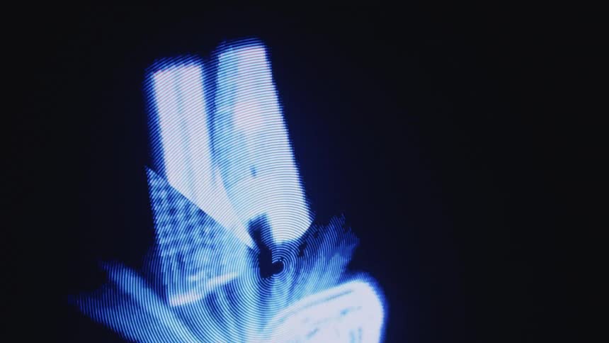 The fingers of a digitized holographic hand open as the letters ai rotate in a beam above the palm