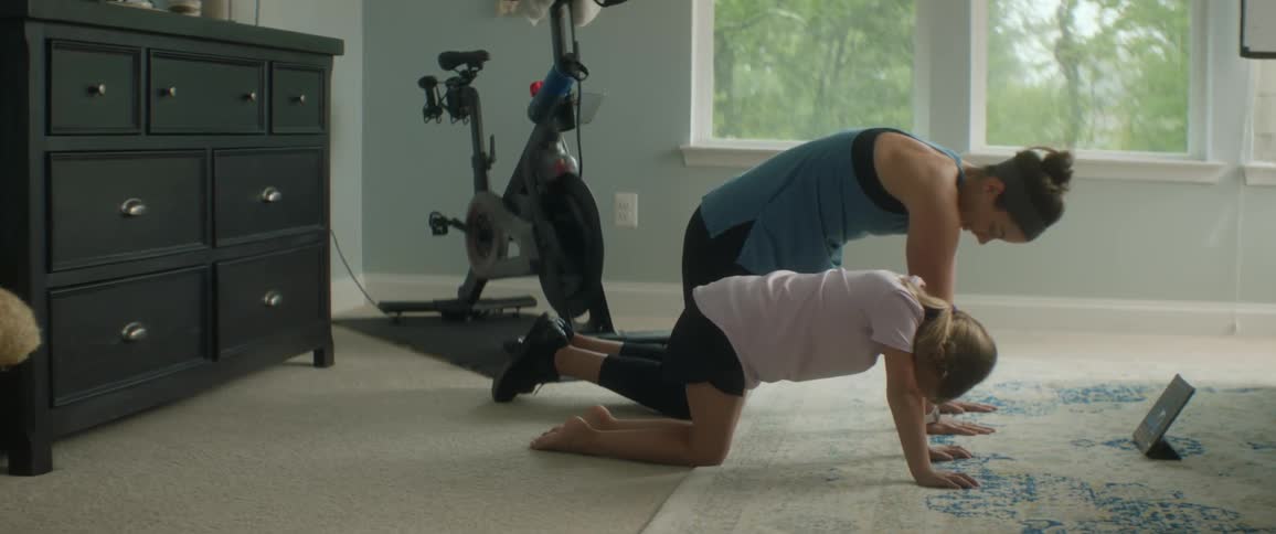 Mother and child doing yoga in a room