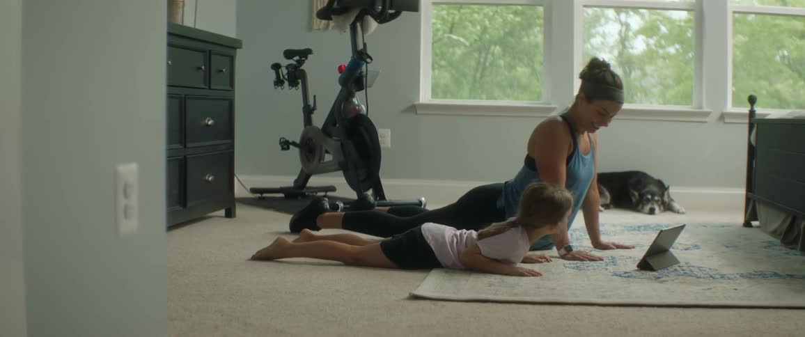 Mother and daughter doing yoga in there room