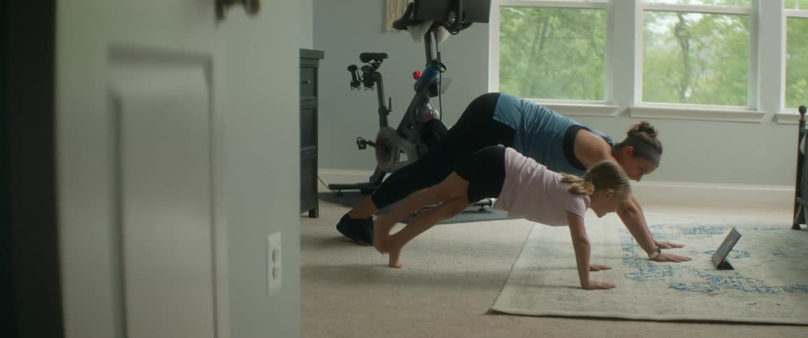 Mother and daughter doing yoga indoors