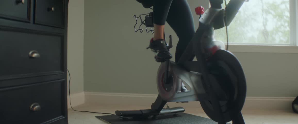 A woman is exercising on a bike