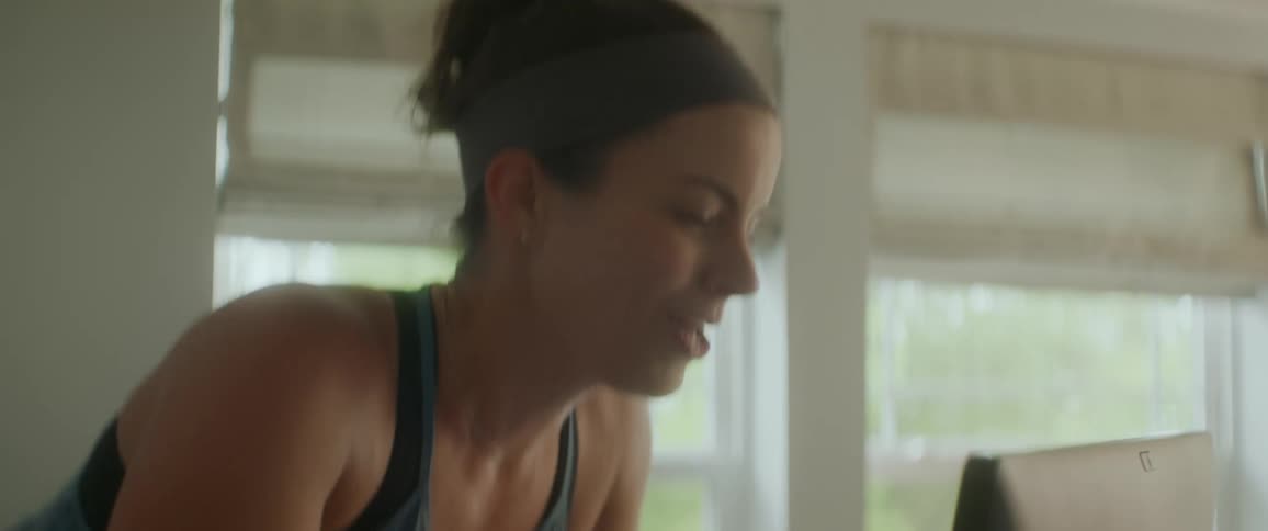A woman is exercising indoors during the day