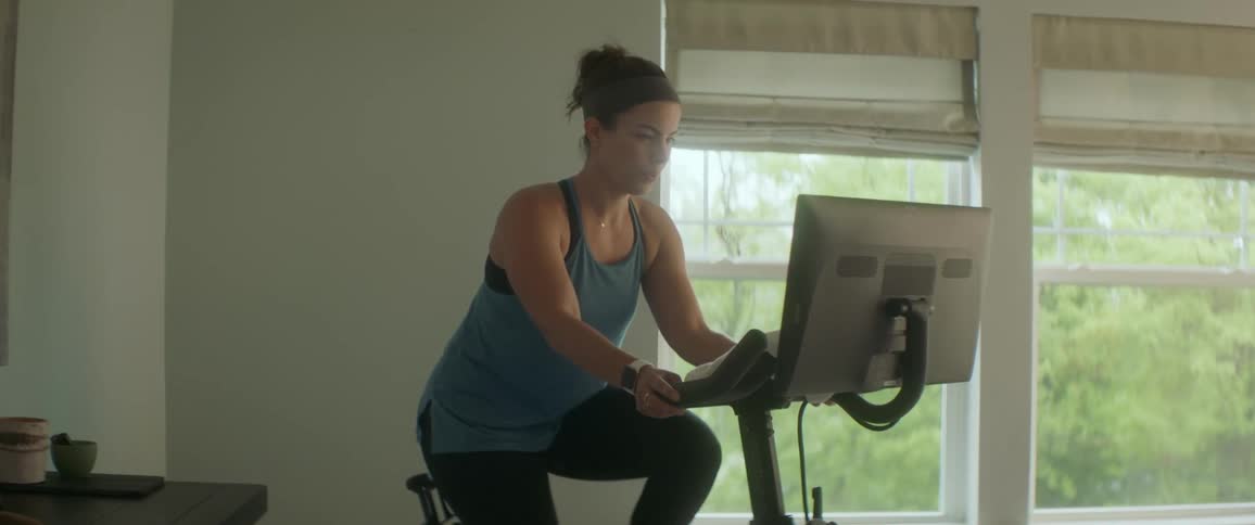 A woman is exercising on a bike