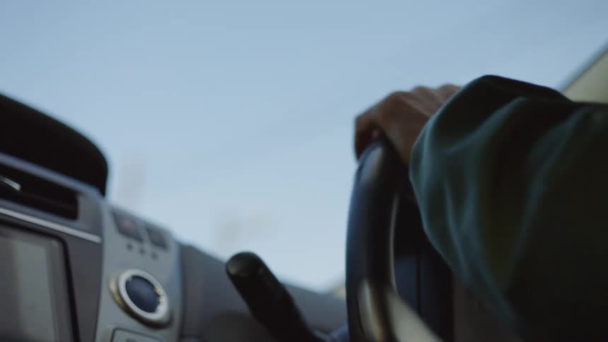 A person is driving a car during the spring