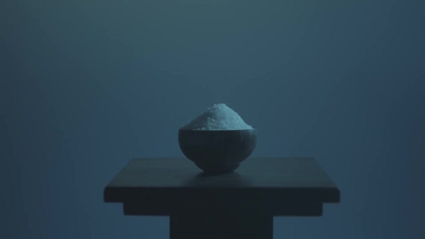 A bowl of white powdery flakes on a table