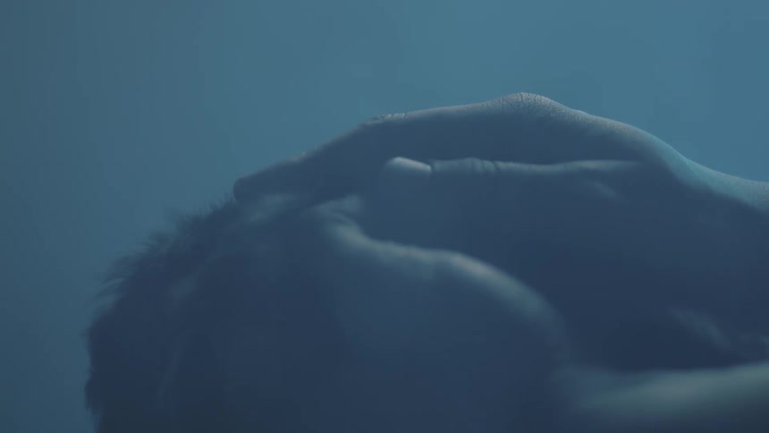 Hands are moving through some hair