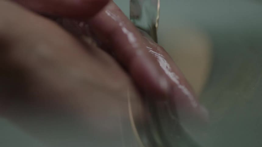 A person washes their hands