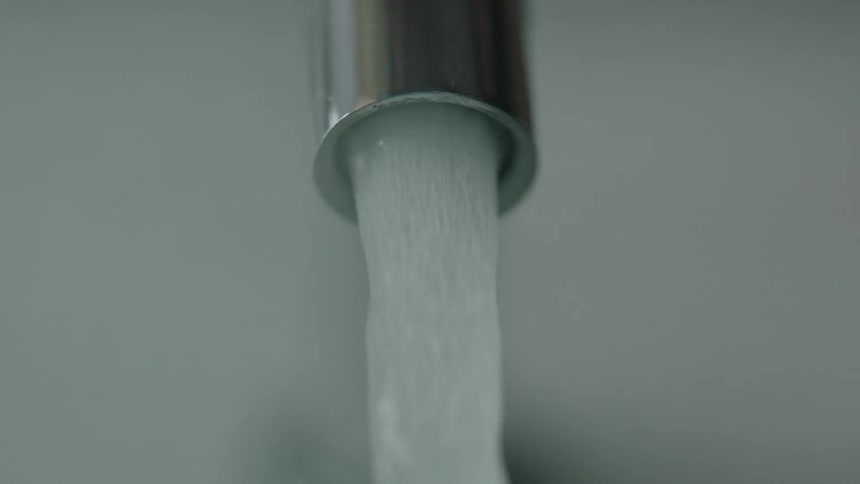 Water pours through a faucet