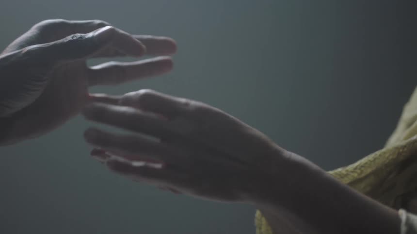 A person hands off a piece of jewelry