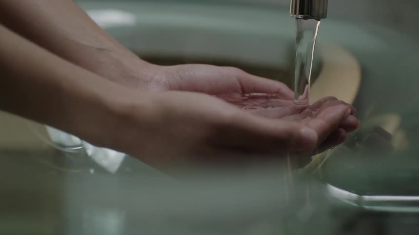 A person runs water over their hands