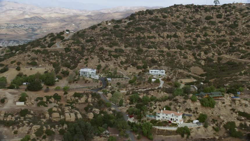 This is a breathtaking aerial view of hillside homes in Canoga Park CA with a beautiful Southern California landscape in the background