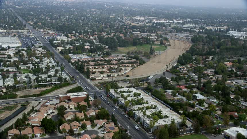 A aerial footage showcasing suburban homes and apartments in Northridge California shot during daytime in summer