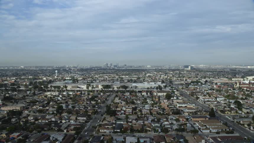 Aerial footage taking off from Hawthorne Airport and flying over a residential area in California
