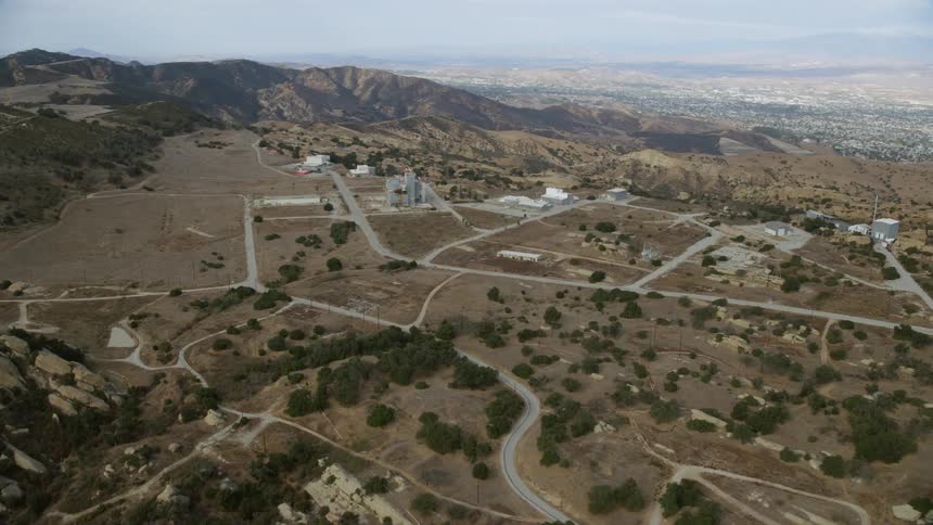 Approaching the rundown and deserted Rocketdyne aerospace testing facility in Brandeis California while filming California Aerials during the Summer daytime