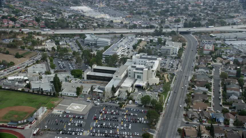 This clip features an epic aerial view of the Providence Holy Cross Medical Center and its surrounding parking lot and city buildings in Mission Hills California shot during summer using a Shotover F1 with an Epic Helium camera on a day with overcast skie
