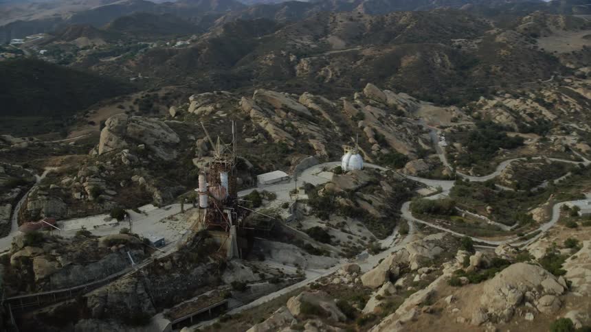 Approaching Rocketdyne Aerospace Testing Facility in Brandeis California with aerial stock footage during the daytime