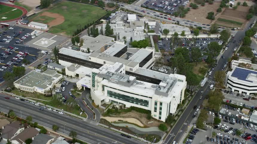 Approaching and orbiting Providence Holy Cross Medical Center in Mission Hills CA during an overcast day