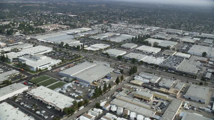 A sweeping aerial shot of mobile homes and warehouses in the commercial sector of Chatsworth California on a cloudy day
