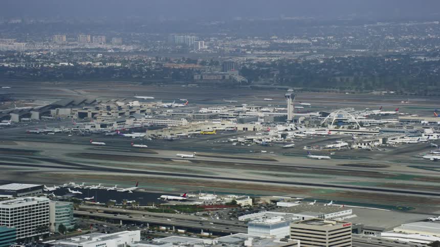  aerial footage capturing a plane taking off from LAX on a cloudy day in Los Angeles California