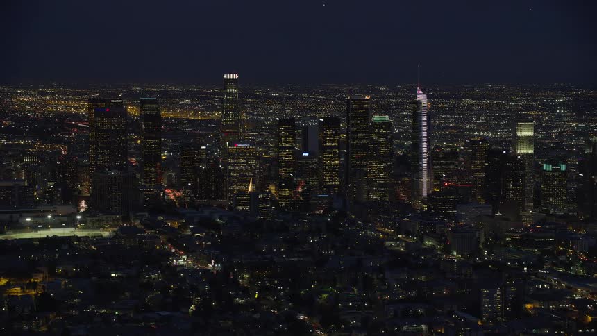 Slowly approaching the iconic tall towers of Downtown Los Angeles on a partly cloudy night