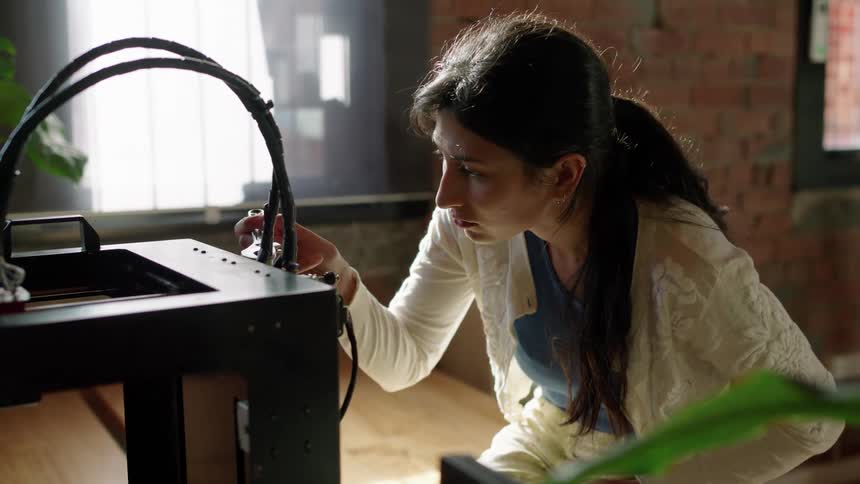A woman is fixing some electronics at her house