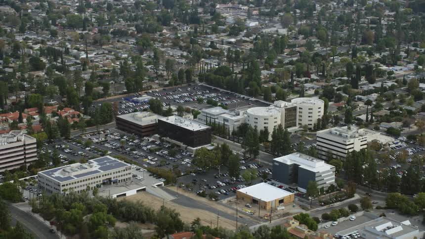 This is a aerial footage of the West Hills Hospital complex in California shot during daytime with cloudy skies in the background
