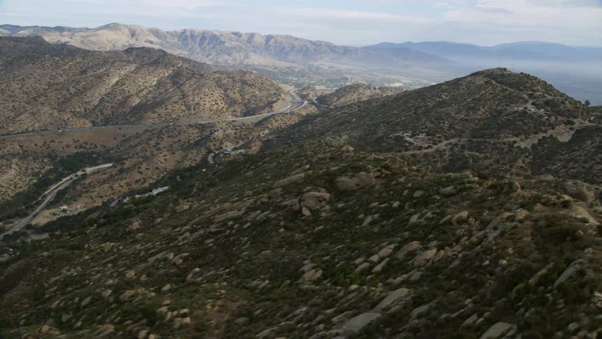 A breathtaking aerial view of picturesque Simi Valley hills and winding roads approaching San Fernando Valley in Southern California