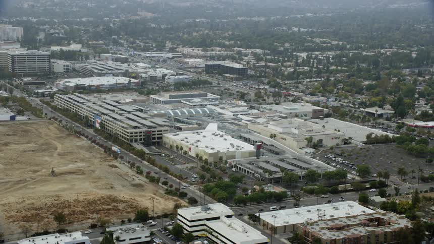 Aerial footage orbiting Target and Macys at Westfield Topanga Mall in Woodland Hills California on a cloudy day
