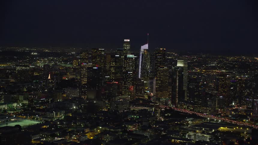  aerial stock footage flying by skyscrapers at nighttime in Downtown Los Angeles